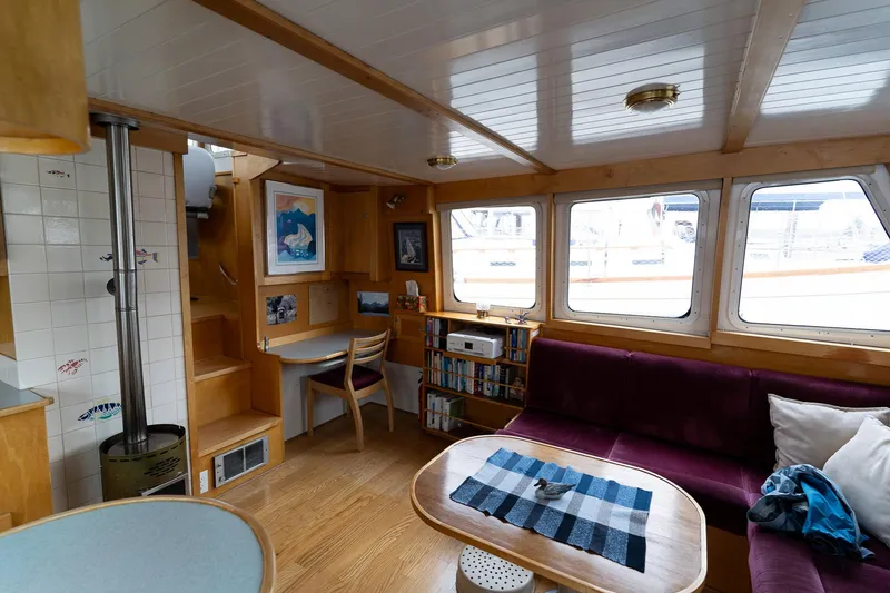Slide: The Image of Cozy interior of a 1997 Custom Steel Trawler with wood accents and large windows. - 16