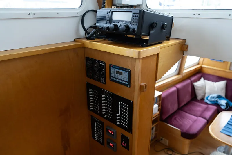 Slide: The Image of Interior of a 1997 Custom Steel Trawler with radio equipment and cozy seating area. - 29