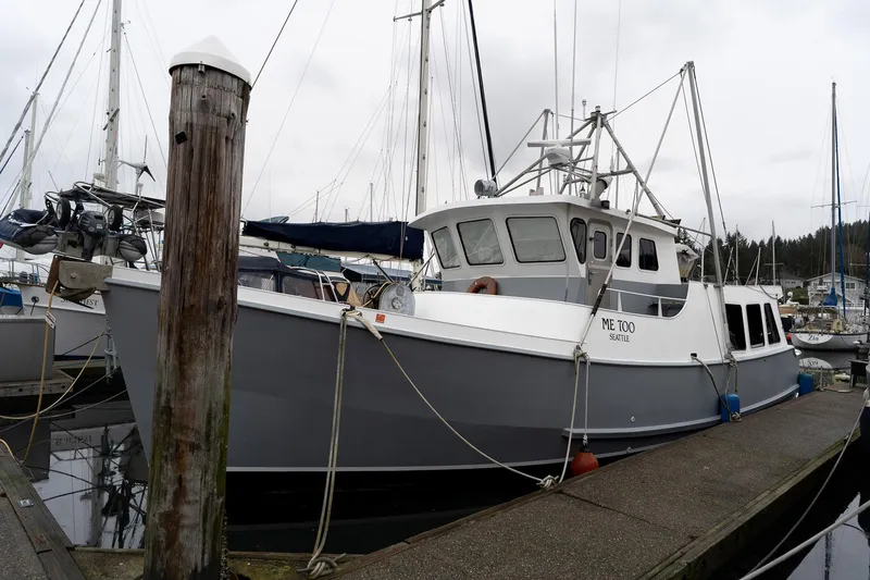 Slide: The Image of Custom 1997 Steel Trawler docked at marina, surrounded by sailboats. - 3