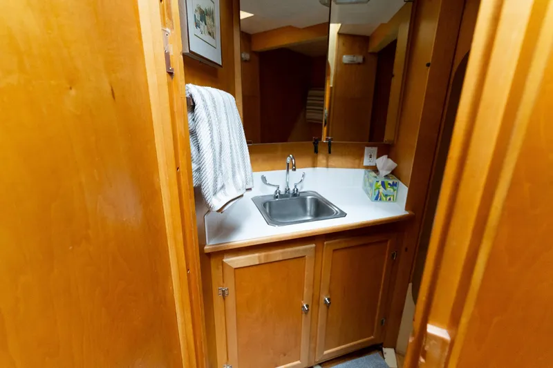 Slide: The Image of Wood-paneled bathroom with sink on 1997 Custom Steel Trawler yacht. - 32