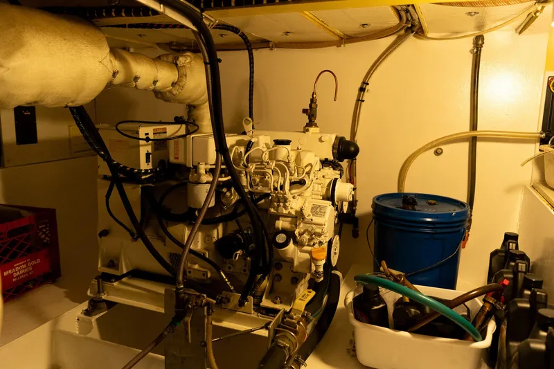 Slide: The Image of Engine room of a 1997 Custom Steel Trawler with machinery and maintenance equipment. - 38