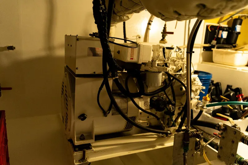 Slide: The Image of Engine room of a 1997 Custom Steel Trawler, showcasing machinery and equipment. - 39