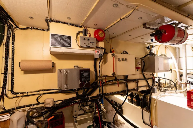 Slide: The Image of Engine room of a 1997 Custom Steel Trawler with control panels and safety equipment. - 41