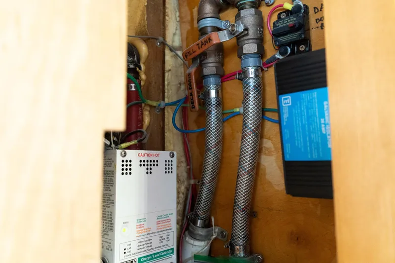 Slide: The Image of Electrical and plumbing components inside a 1997 Custom Steel Trawler boat. - 42