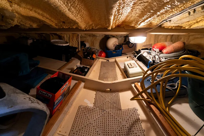 Slide: The Image of Interior of a 1997 Custom Steel Trawler, showcasing storage and equipment. - 44