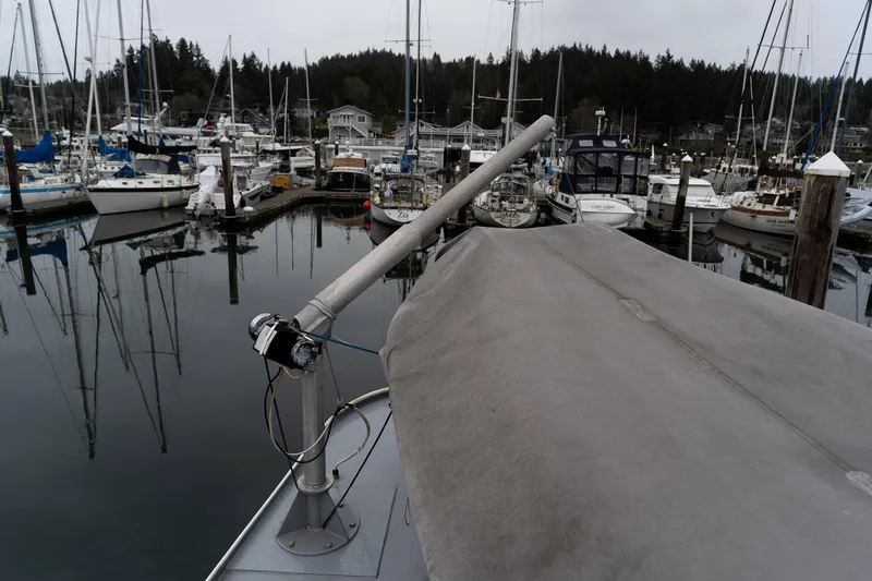 Slide: The Image of Docked 1997 Custom Steel Trawler in a marina with surrounding sailboats. - 8