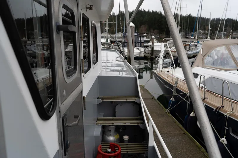 Slide: The Image of Side view of a 1997 Custom Steel Trawler docked at a marina. - 9