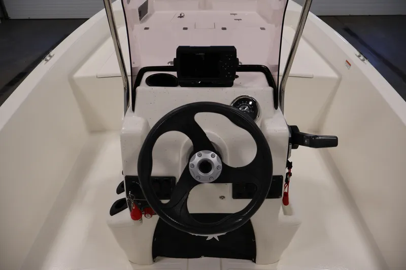 Slide: The Image of 2022 Mako Pro Skiff 17 CC boat console with steering wheel and controls. - 17
