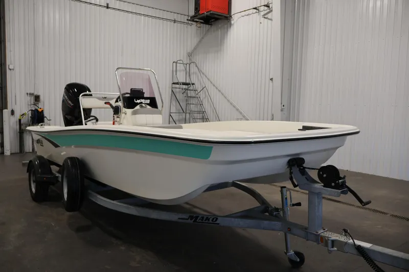 Slide: The Image of 2022 Mako Pro Skiff 17 CC boat on trailer in indoor storage. - 2