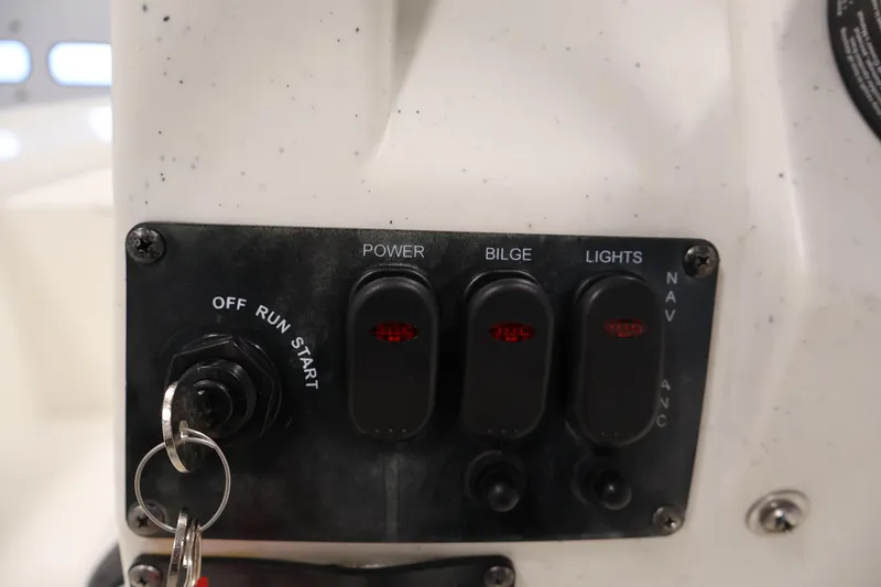 Slide: The Image of Control panel of a 2022 Mako Pro Skiff 17 CC boat with switches and ignition. - 21