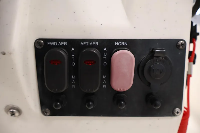 Slide: The Image of Control panel of a 2022 Mako Pro Skiff 17 CC boat with switches and 12V outlet. - 22