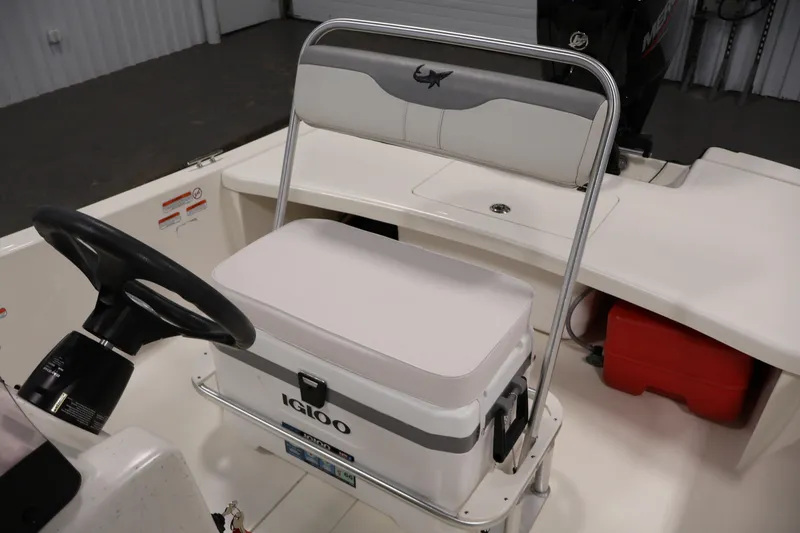 Slide: The Image of 2022 Mako Pro Skiff 17 CC interior with steering wheel and Igloo cooler seat. - 23
