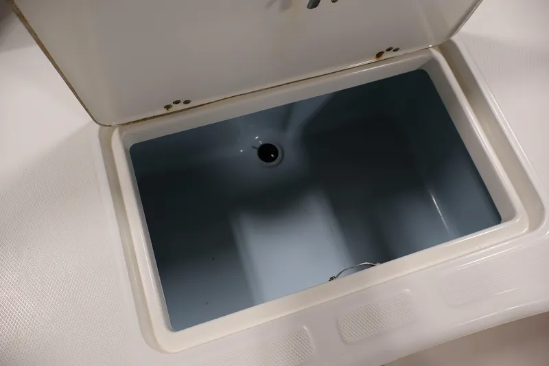 Slide: The Image of Open storage compartment on 2022 Mako Pro Skiff 17 CC boat. - 26
