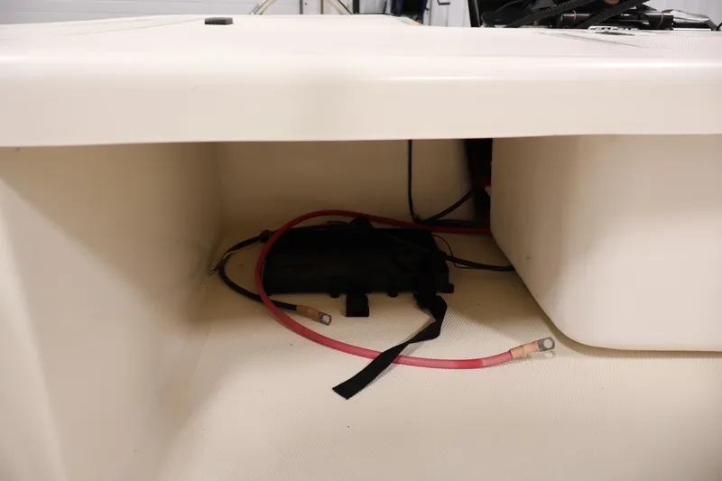 Slide: The Image of Storage compartment of 2022 Mako Pro Skiff 17 CC with cables and equipment. - 27