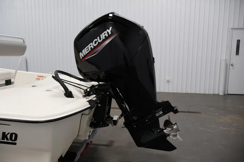 Slide: The Image of 2022 Mako Pro Skiff 17 CC with Mercury outboard motor in a garage setting. - 29
