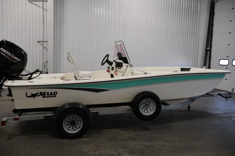 Slide: The Image of 2022 Mako Pro Skiff 17 CC boat on trailer in indoor setting. - 3