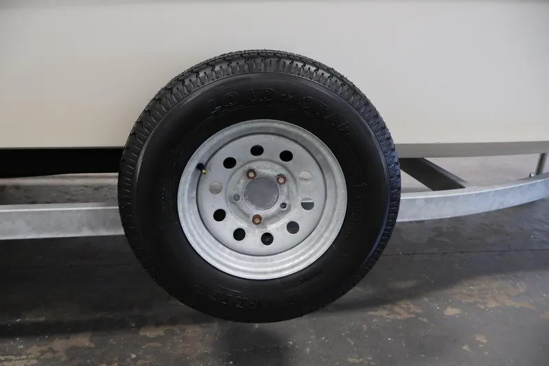 Slide: The Image of Trailer wheel of a 2022 Mako Pro Skiff 17 CC boat. - 34