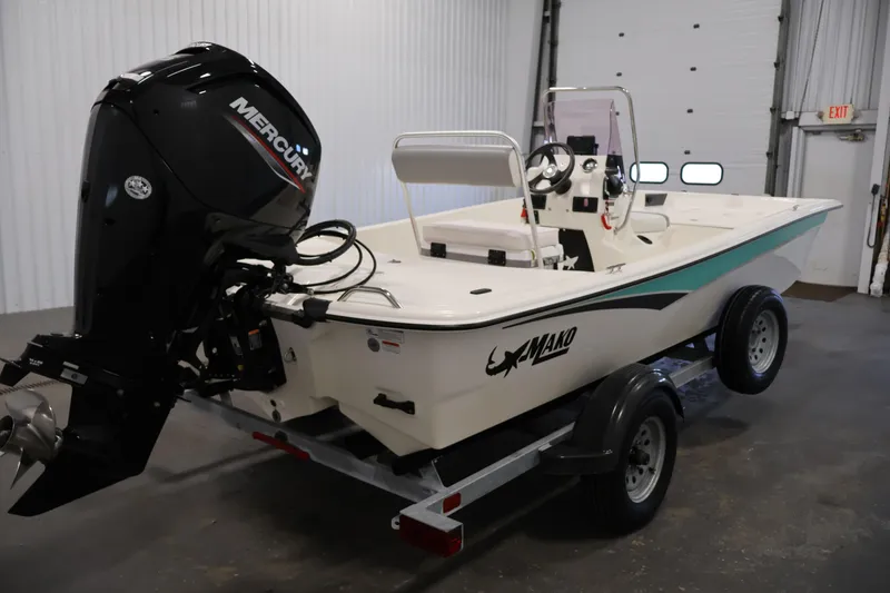 Slide: The Image of 2022 Mako Pro Skiff 17 CC boat with Mercury engine on trailer in garage. - 4