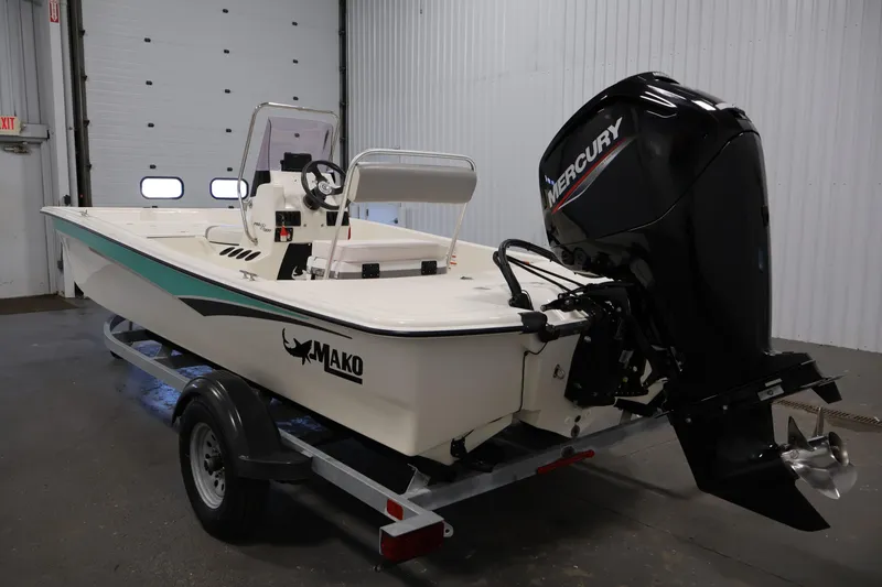 Slide: The Image of 2022 Mako Pro Skiff 17 CC boat with Mercury engine on trailer in garage. - 6
