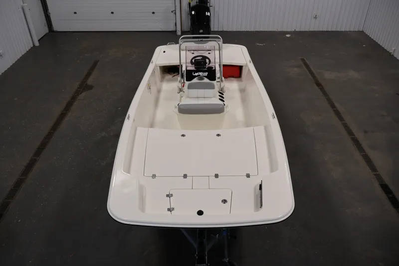 Slide: The Image of 2022 Mako Pro Skiff 17 CC boat in a garage, top view. - 8
