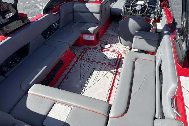 Slide: The Image of 2022 Moomba Mojo boat interior with gray seating and red accents. - 10