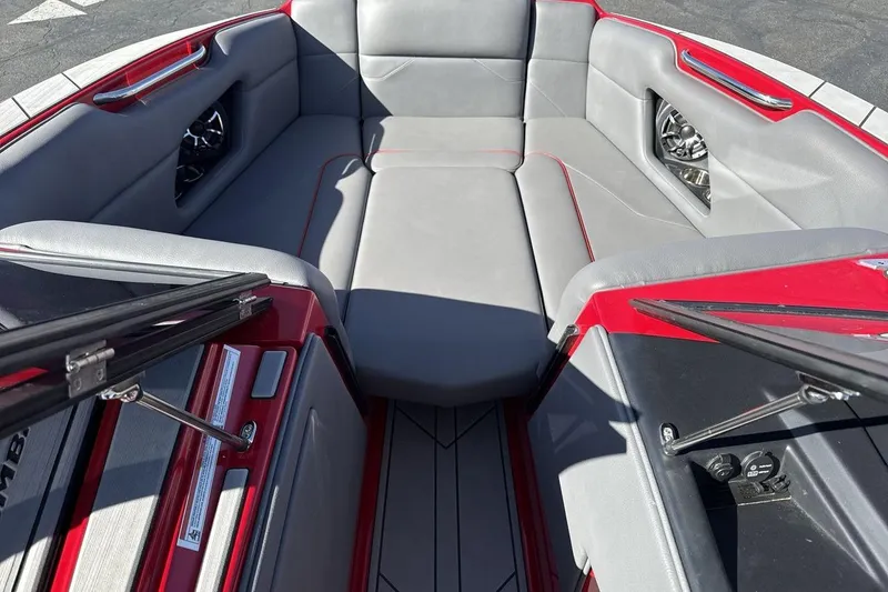 Slide: The Image of 2022 Moomba Mojo boat interior with gray seating and red accents. - 11