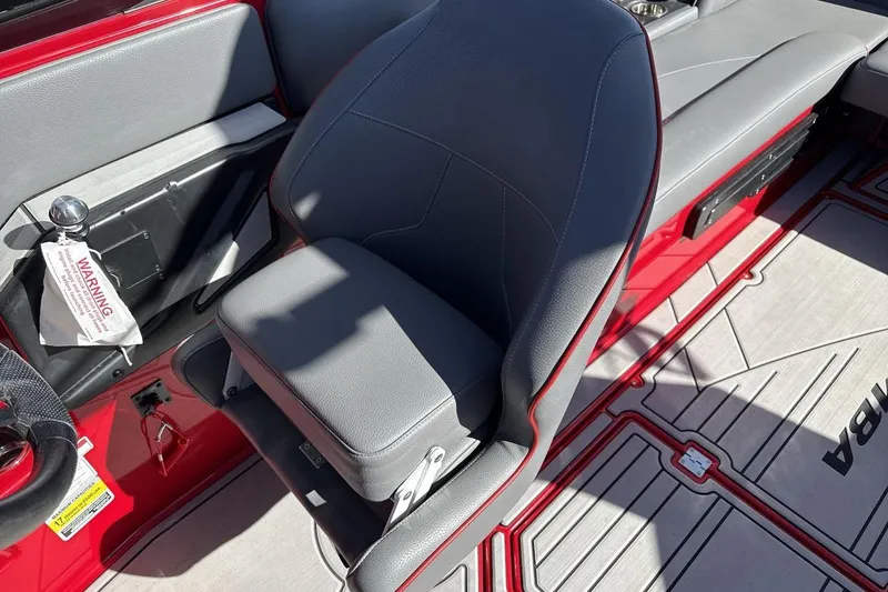 Slide: The Image of 2022 Moomba Mojo boat interior with gray seating and red accents. - 13