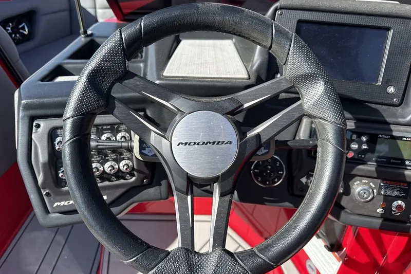 Slide: The Image of Steering wheel of 2022 Moomba Mojo boat with dashboard controls. - 14