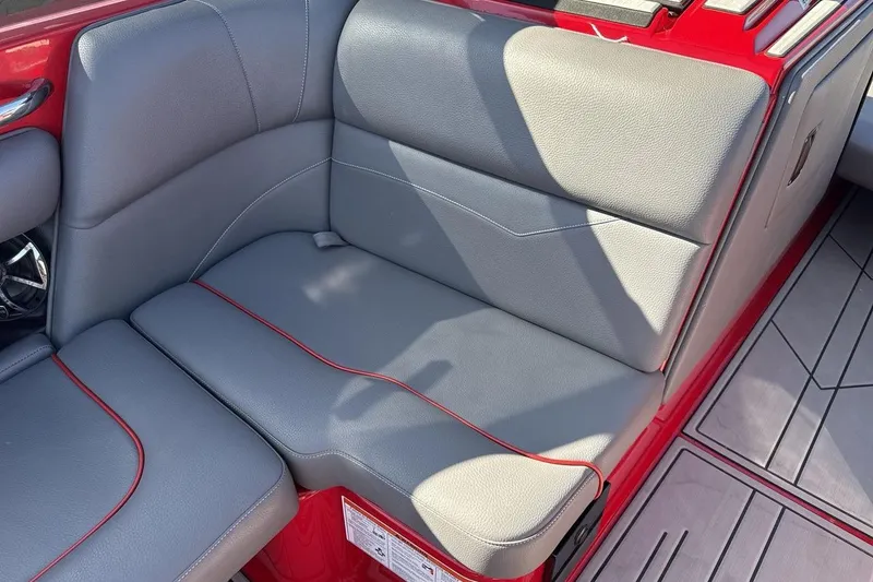 Slide: The Image of 2022 Moomba Mojo boat interior with gray seating and red accents. - 17