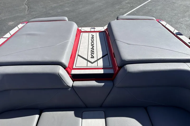 Slide: The Image of 2022 Moomba Mojo boat interior with gray seating and red accents. - 19