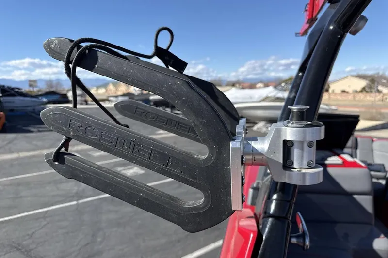 Slide: The Image of Roswell wakeboard rack on 2022 Moomba Mojo boat, sunny day, outdoor setting. - 22