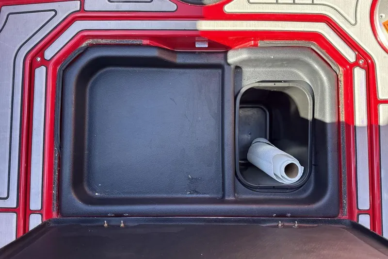 Slide: The Image of Storage compartment in a 2022 Moomba Mojo boat with a paper towel roll. - 23