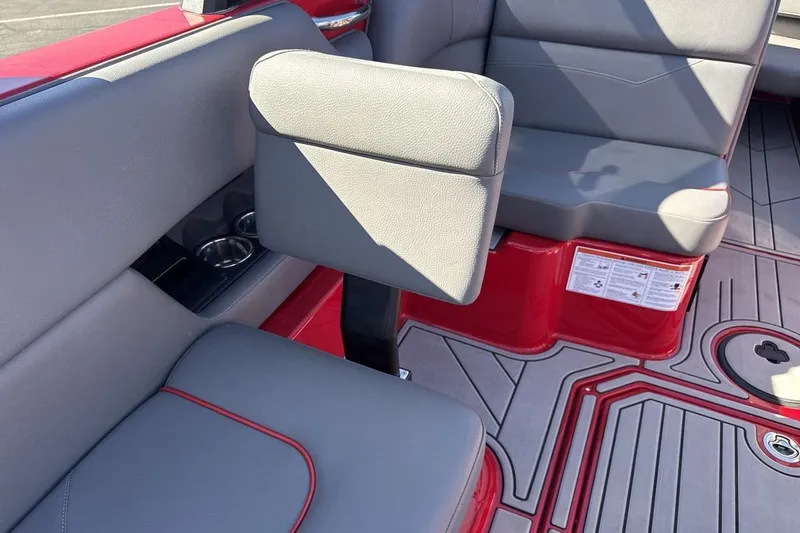 Slide: The Image of 2022 Moomba Mojo boat interior with gray seating and red accents. - 24