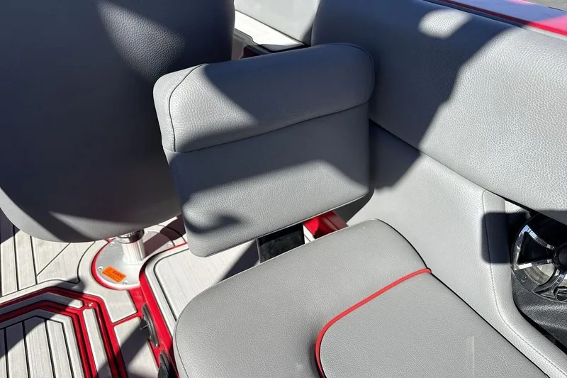 Slide: The Image of 2022 Moomba Mojo boat interior with gray seating and red accents. - 25