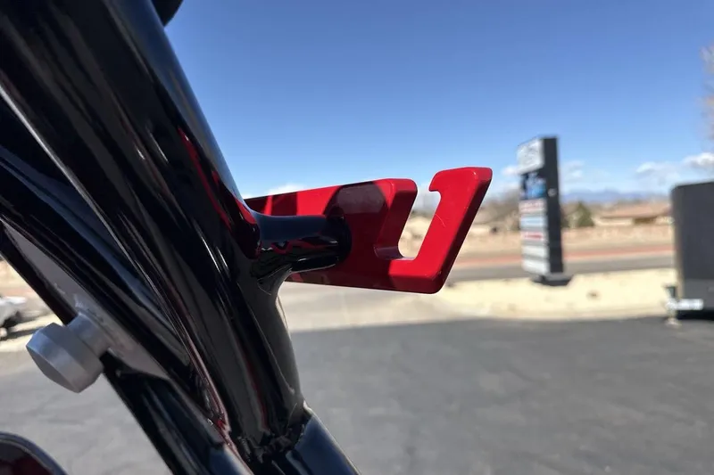 Slide: The Image of Close-up of a red metal component on a 2022 Moomba Mojo boat. - 26