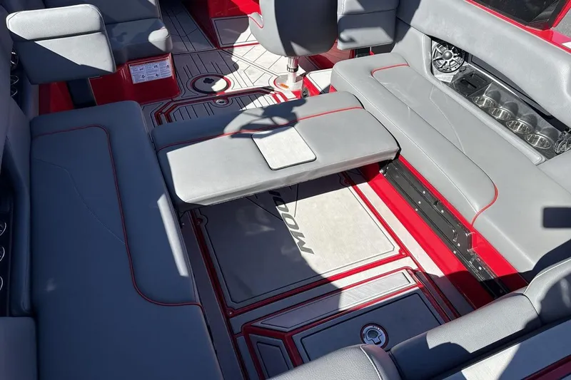 Slide: The Image of Interior of a 2022 Moomba Mojo boat with gray seating and red accents. - 27
