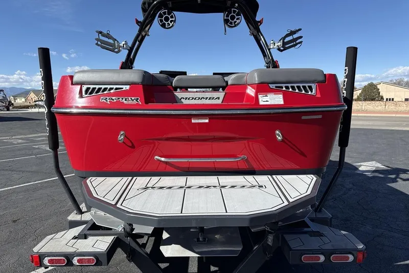 Slide: The Image of 2022 Moomba Mojo boat, red exterior, parked on trailer, rear view. - 4