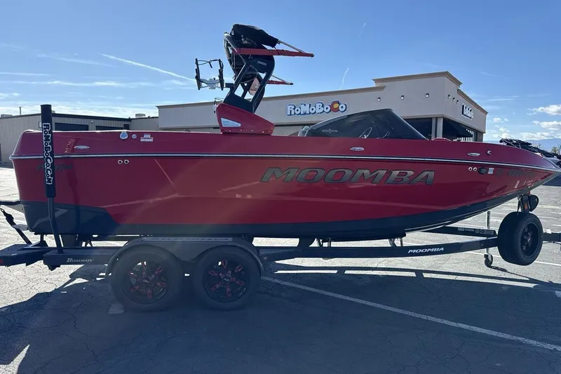 Slide: The Image of Red 2022 Moomba Mojo boat on trailer in parking lot, sunny day. - 6