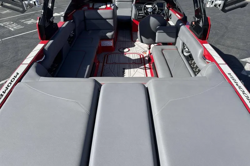 Slide: The Image of 2022 Moomba Mojo boat interior with gray seating and modern dashboard design. - 9