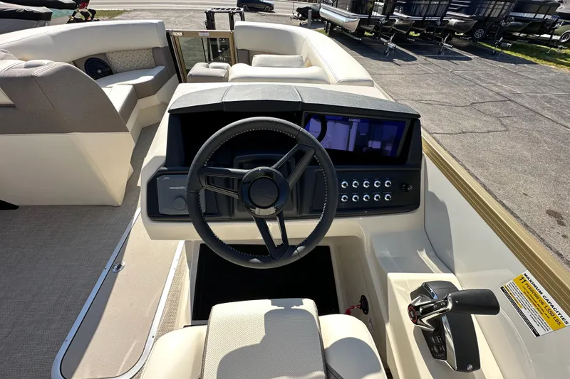 Slide: The Image of Steering console of 2026 Alera M23Q boat with modern controls and seating. - 12