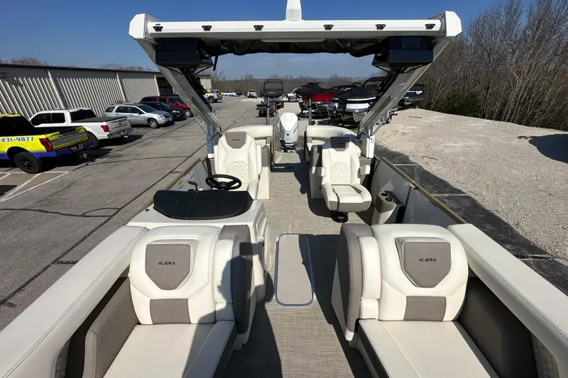 Slide: The Image of 2026 Alera M23Q boat with luxurious seating and modern design in a parking area. - 19