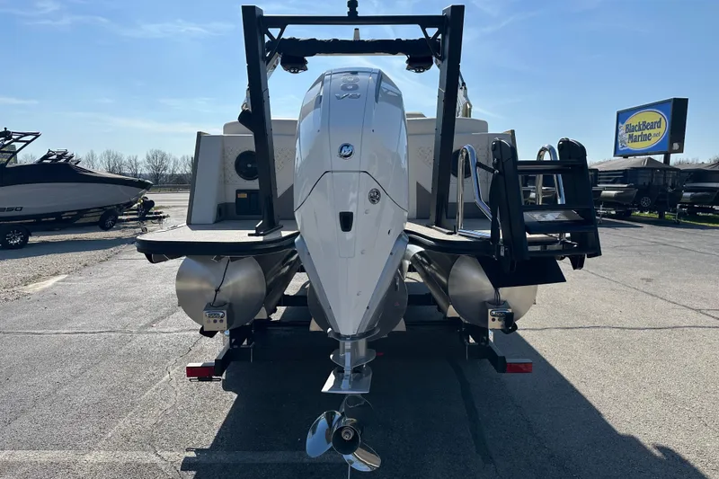 Slide: The Image of 2026 Alera M23Q boat with powerful outboard motor, parked at BlackBeard Marine dealership. - 4