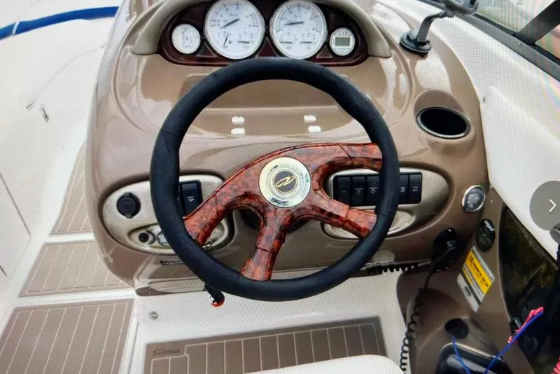 Slide: The Image of Steering wheel and dashboard of a 2005 Regal 2400 Bowrider boat. - 12