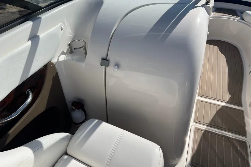 Slide: The Image of 2005 Regal 2400 Bowrider interior with white seating and wood accents. - 17