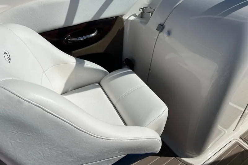 Slide: The Image of White leather seat in a 2005 Regal 2400 Bowrider boat, showcasing luxury interior design. - 18