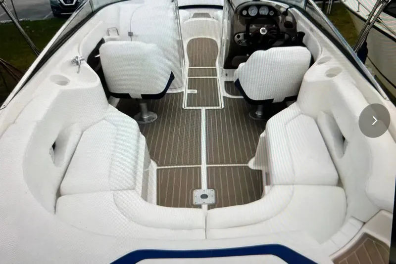 Slide: The Image of 2005 Regal 2400 Bowrider interior with white seating and sleek dashboard design. - 19