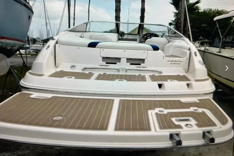Slide: The Image of 2005 Regal 2400 Bowrider boat with spacious deck and seating area. - 22