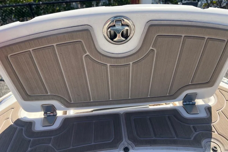 Slide: The Image of 2005 Regal 2400 Bowrider boat hatch with textured design and metal hinges. - 23