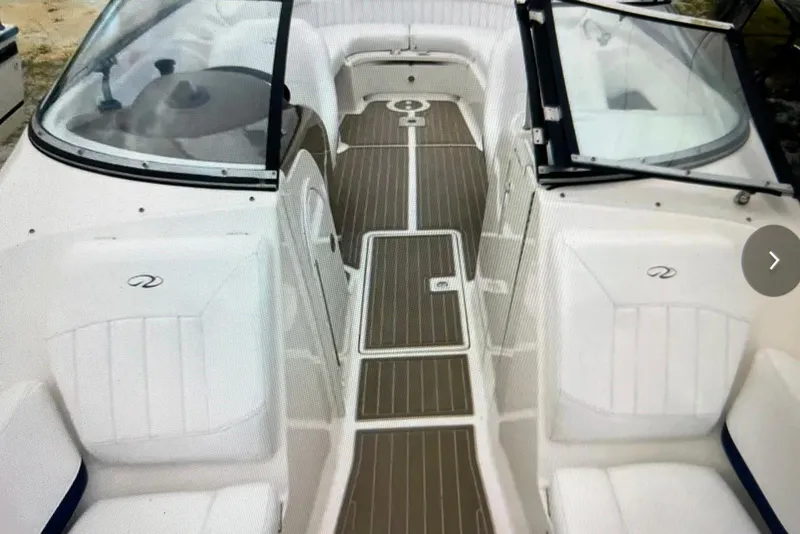 Slide: The Image of 2005 Regal 2400 Bowrider interior with sleek seating and wood-style flooring. - 24
