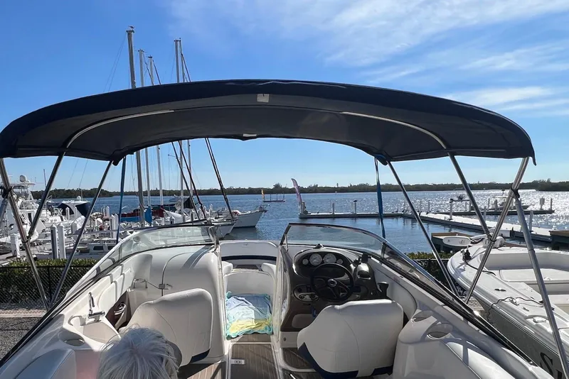 Slide: The Image of 2005 Regal 2400 Bowrider boat docked at marina with clear blue sky. - 26